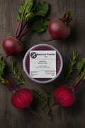 Beetroot powder container with label on a rustic background