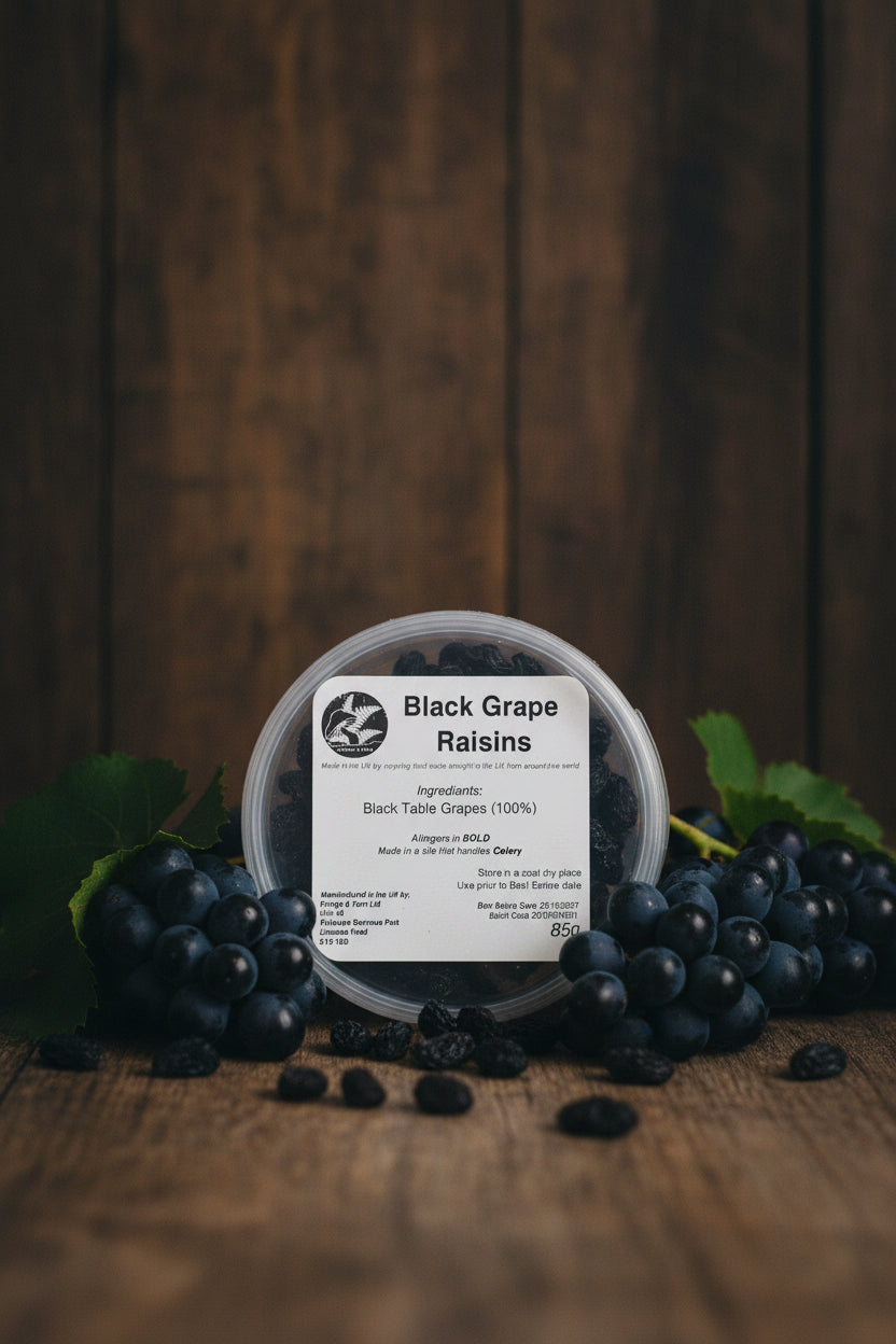 Pot of black grape raisins with a label on a rustic background