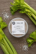 Pot of celery salt with a label on a rustic background