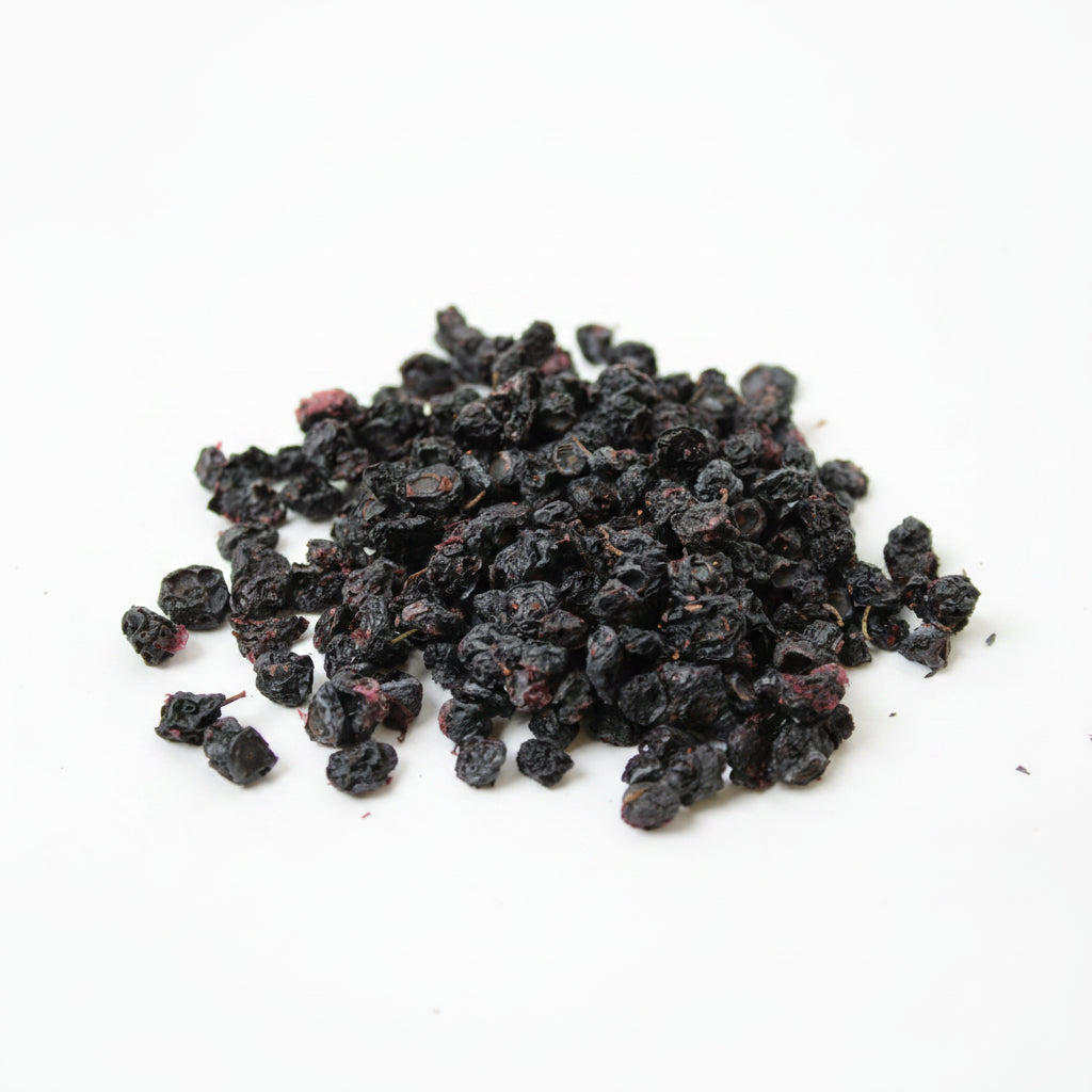 Pile of dried black berries on a white background